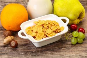 Breakfast with corn flakes and milk photo