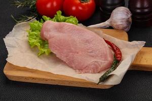 Raw Turkey steak served rosemary photo