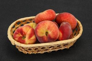 Sweet ripe tasty flat peach photo