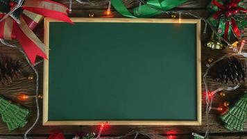 Santa's hand laid wooden letters for the word Happy New Year on the blackboard.
