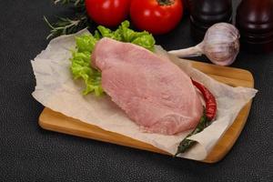 Raw Turkey steak served rosemary photo
