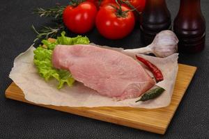 Raw Turkey steak served rosemary photo