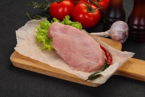 Raw Turkey steak served rosemary photo