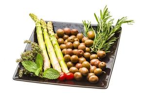 Olives, asparagus, rosemary, mint, thyme and tomato photo