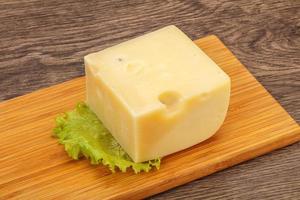 Emmental cheese over wooden board photo