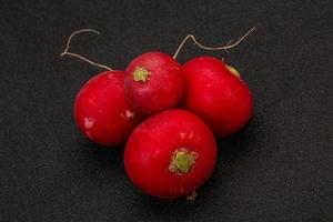 Ripe fresh radish heap over wooden photo