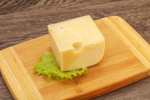 Emmental cheese over wooden board photo