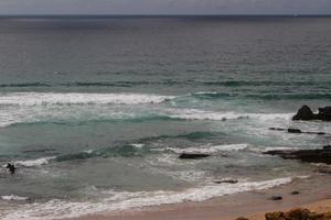 The waves fighting about deserted rocky coast of Atlantic ocean, Portugal photo