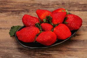 Ripe sweet strawberry with leaf photo