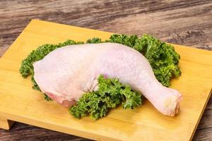 Raw chicken leg for cooking photo