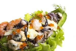 Seafood salad with red caviar in avocado photo