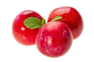 Bright ripe plum with mint photo