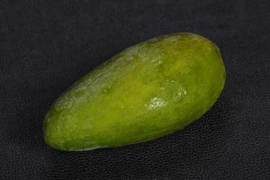 Green tasty mango over wooden background photo