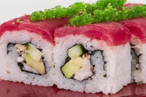 Maki Sushi - Roll made of Crab, avocado, cucumber inside. Fresh Tuna and tobico roe outside photo