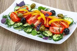 Salad with tomato, cucumber and olives photo
