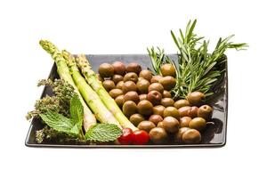 Olives, asparagus, rosemary, mint, thyme and tomato photo