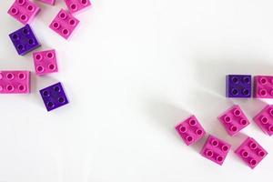 Rose and purple plastic building blocks with empty copyspace photo