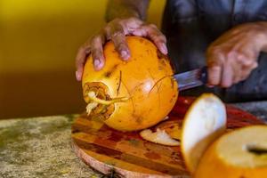 Preparing of a coconut for drinking on a Hikkaduwa market at Sri Lanka photo