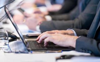 close up of business people hands using laptop computer photo