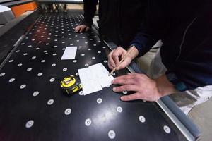 carpenters calculating and programming a cnc wood working machine photo