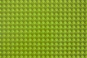 Green plastic building blocks mat with empty copyspace photo