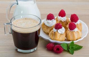 Profiterole with raspberry photo