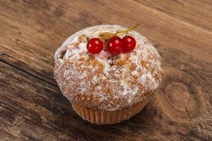 Sweet tasty muffin with red currants photo