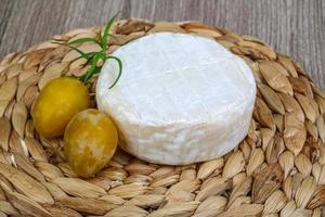 Brie cheese with yellow plums photo