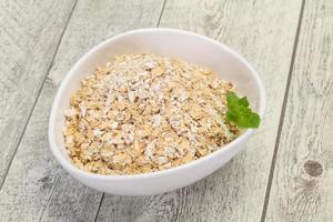 Raw oats in the bowl photo