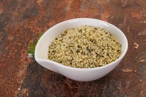 Peeled hemp seeds in the bowl photo
