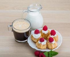 Profiterole with raspberry photo