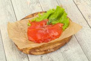 Sliced salmon fillet served rosemary photo