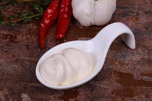 Mayonnaise sauce in the white bowl served thyme and garlic photo