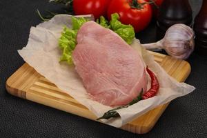 Raw Turkey steak served rosemary photo
