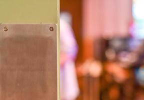 Restaurant wooden door with metal plate. Selective focus. With copy space. photo