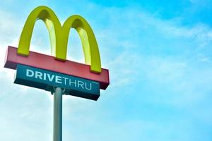 chachoengsao, tailandia. 8 de julio de 2021. El restaurante mc donald's conduce un verdadero signo sobre el cielo azul. mcdonald's es una cadena de comida rápida estadounidense que es muy popular en tailandia foto