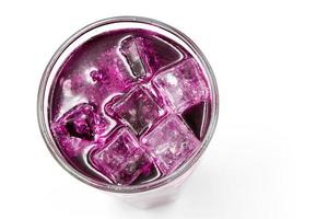 Grape sparkling water with Ice in glass over white background. photo