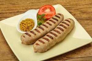 Grilled natural pork sausages with sauce photo