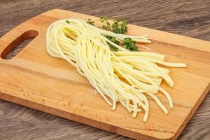 Chechil spaghetti cheese over board photo