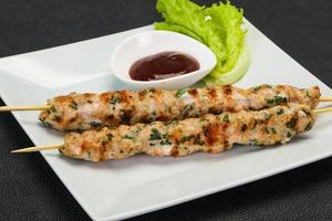 Minced pork skewer kebab with sauce photo