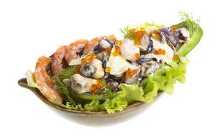 Seafood salad with red caviar in avocado photo