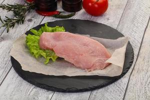 Raw Turkey steak served rosemary photo