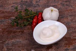 Mayonnaise sauce in the white bowl served thyme and garlic photo