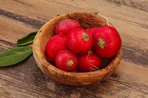 Ripe fresh radish heap over wooden photo