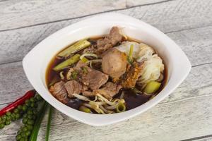 Thai style soup with meat and mushrooms photo