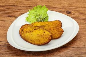 Baked potato with herbs and spices photo