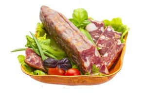 Ripe salami with salad, basil, onion and tomato photo