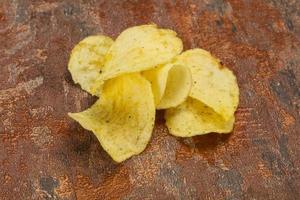 Natural potato salted chips heap photo