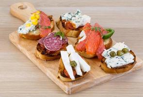 Tapas with cheese, salami and salmon photo