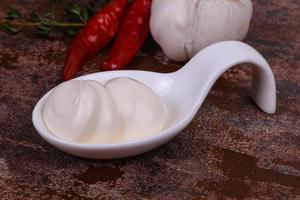 Mayonnaise sauce in the white bowl served thyme and garlic photo